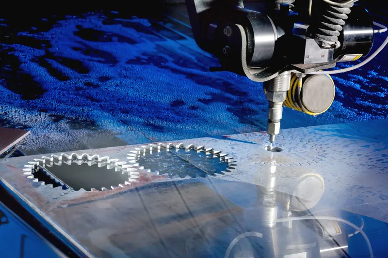 Abrasive waterjet cutting head making a precision cut on a metal plate
